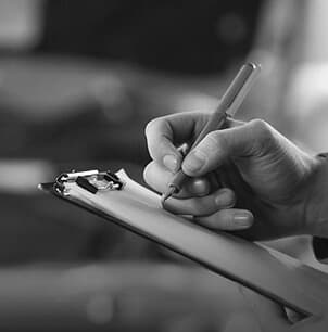 Hand writing on a clipboard to select services